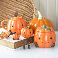 Cute smiling pumpkin wax/oil burner by Twink Candle Company, styled autumn display