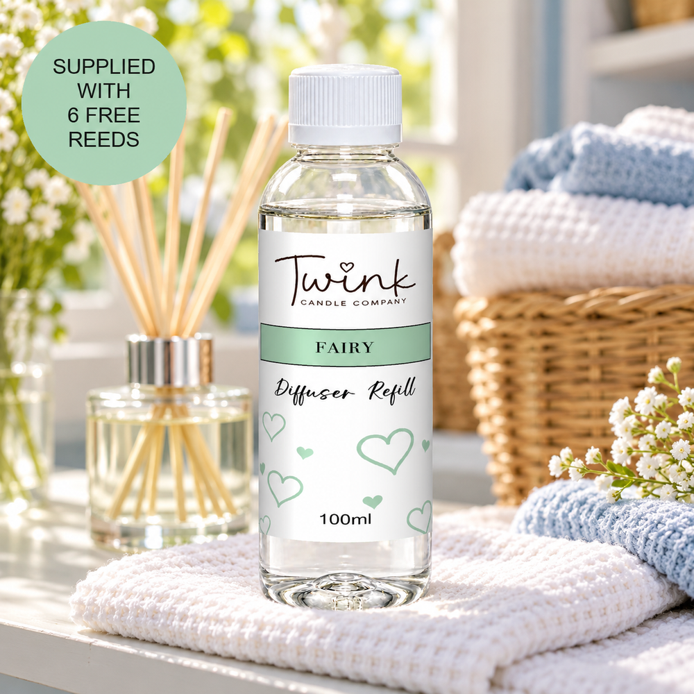 Fairy reed diffuser refill by Twink Candle Company, a 100ml bottle on a folded white towel in a sunlit laundry room