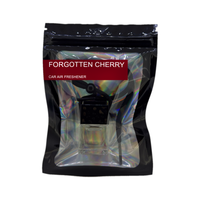 Forgotten Cherry car air freshener by Twink Candle Company, hanging car vent clip diffuser on a white background