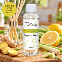 Lemongrass & Ginger reed diffuser refill by Twink Candle Company, a 100ml bottle on a bamboo board with fresh ginger root, lemongrass and lemon