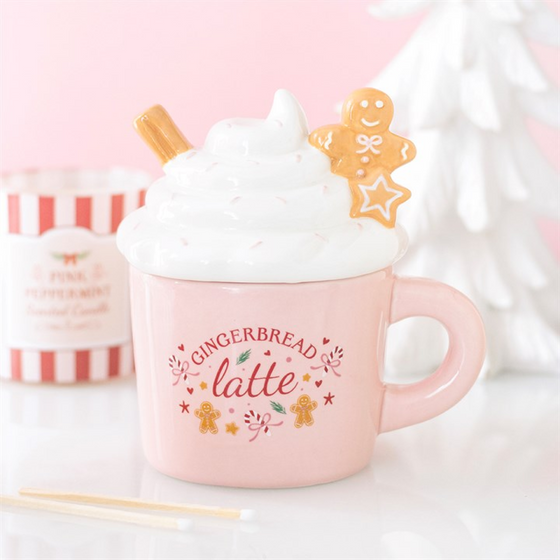 Pink gingerbread latte wax/oil burner by Twink Candle Company — a pink latte mug burner topped with cream, a cinnamon stick and a gingerbread man, with 'Gingerbread Latte' lettering