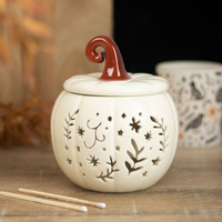 Cream folk pumpkin wax/oil burner by Twink Candle Company — cream ceramic pumpkin with folk-style cut-outs and a rust-red curled stalk