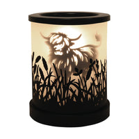 Highland cow black shadow wax and oil burner by Twink Candle Company, shown lit with the silhouette glowing