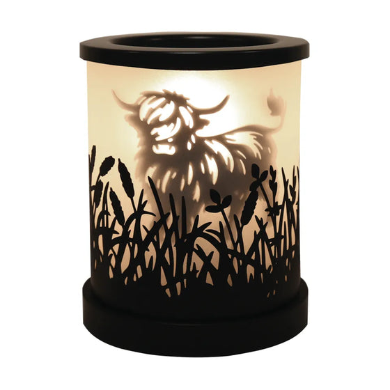Highland cow black shadow wax and oil burner by Twink Candle Company, shown lit with the silhouette glowing