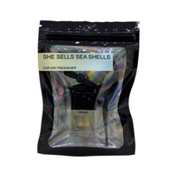 She Sells Sea Shells car air freshener by Twink Candle Company, hanging car vent clip diffuser on a white background