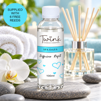 Spa Days reed diffuser refill by Twink Candle Company, a 100ml bottle on a stone slab with rolled white towels and a white orchid