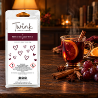 Spicy Mulled Wine inspired soy wax melt snap bar by Twink Candle Company, stood on a dark wood table beside a glass of warm mulled wine, cinnamon sticks and star anise