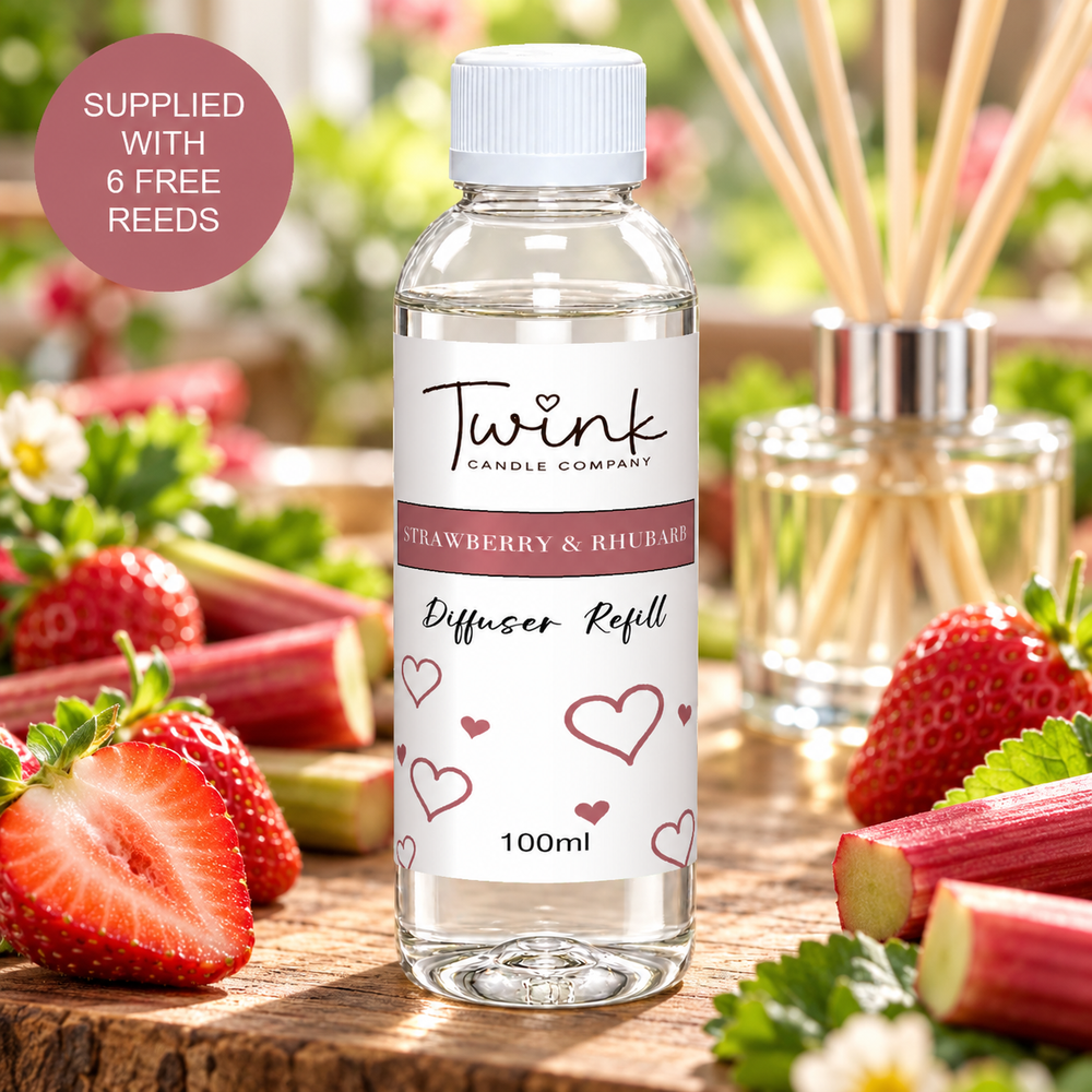 Strawberry & Rhubarb reed diffuser refill by Twink Candle Company, a 100ml bottle on a wooden board with fresh strawberries and rhubarb