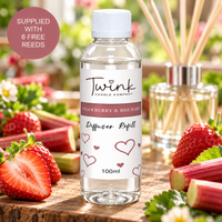 Strawberry & Rhubarb reed diffuser refill by Twink Candle Company, a 100ml bottle on a wooden board with fresh strawberries and rhubarb