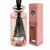 Woodbridge Summer Breeze 1000ml reed diffuser in a pink woven glass bottle with black reeds beside its pink gift box on a plain white background