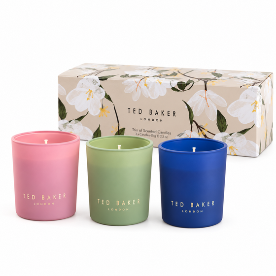 Ted Baker gift set of three 65g scented candles in pink, green and blue frosted glass in front of the floral gift box on a plain white background