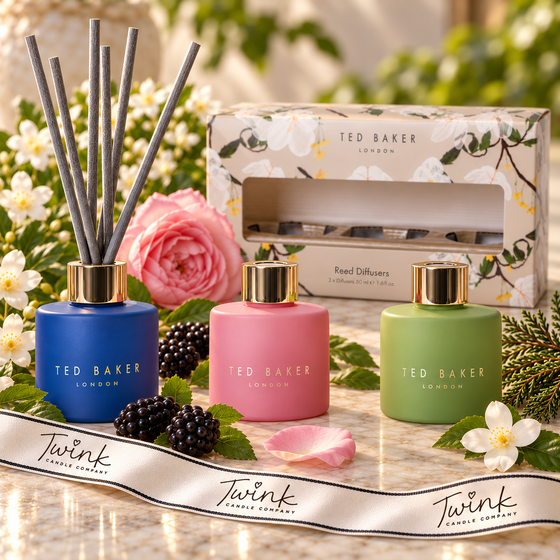 Ted Baker gift set of three 50ml reed diffusers in blue, pink and green glass on pale marble with jasmine, rose, blackberries and cedar, and a Twink Candle Company ribbon