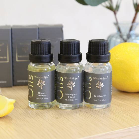 Woodbridge Lemongrass and Sage essential oil 15ml bottle and box styled on wood with a plant behind