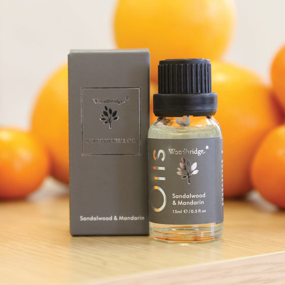 Woodbridge Sandalwood & Mandarin essential oil 15ml bottle and box styled on wood with a plant behind