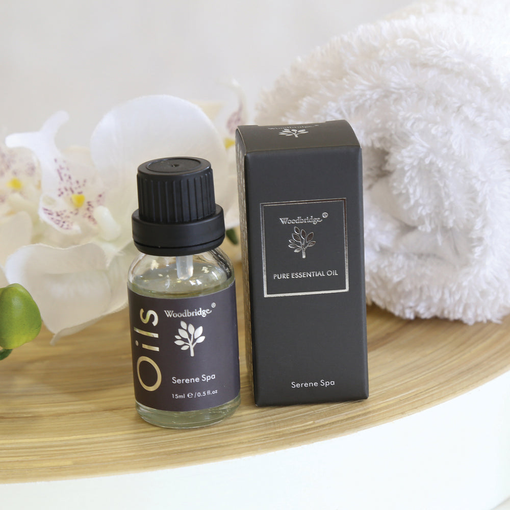 Woodbridge Serene Spa essential oil 15ml bottle and box styled with a towel and flowers